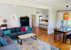 a living room with a couch and a table at Meryta - Your Sanctuary In Town in Burnt Pine