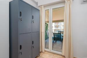 a room with white cabinets and a sliding glass door at Eirini Residence in Athens