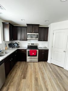 een keuken met houten kasten en een kookplaat met oven bij Peaceful room in new house in Raleigh Downtown Area in Raleigh