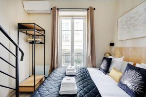 a bedroom with a bed and a window at Apartment with terrace - Parc monceau in Paris +8 photos