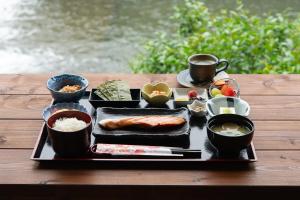 a tray of food on a wooden table with food at Hotel Arashiyama in Kyoto