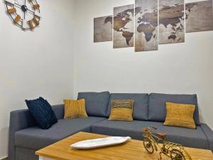 a living room with a blue couch and a table at Apartamento J Burgos - Ole Solutions in El Puerto de Santa María