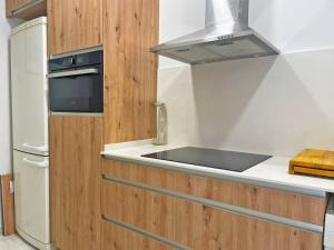 a kitchen with a sink and a stove at Apartamento Villamarta - Ole Solutions in Jerez de la Frontera