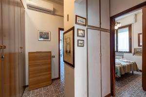 a hallway with a room with a bed at Annamaria's House 200m From Sea - Happy Rentals in Viareggio +13 photos