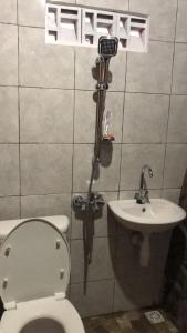 a bathroom with a toilet and a sink at Pondok Kebun Gunung in Bedugul
