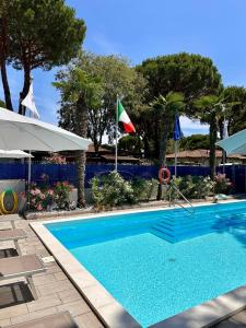 a swimming pool with a flag and a flag at Blue Inn Residence e B&B in Lido delle Nazioni