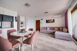 a living room with a table and chairs and a couch at Queen's view 14-Pools-Near Botanic garden in Balchik