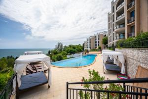 a balcony with a view of a swimming pool at Queen's view 14-Pools-Near Botanic garden in Balchik