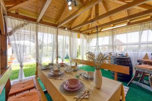 a dining room with a table in a house at Merry's House w/ Pool, Sauna & Jacuzzi - Happy Rentals in Griblje