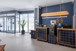 a gas station with blue walls and a payphone at B&B HOTEL Benidorm Finestrat in Finestrat