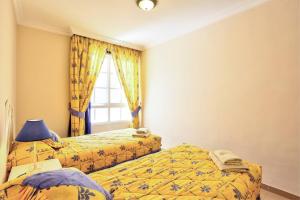 A bed or beds in a room at Amazing View Apt By Dream Homes Tenerife