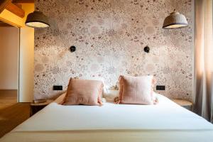 a bedroom with a bed with two pink pillows at Gite d exception avec vue panoramique 4 personnes in Prémanon