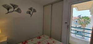 a small bedroom with a bed and a window at Port Frejus, 100 m des plages, le CESAREE, T2 30m2 in Fréjus