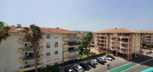 an apartment complex with cars parked in a parking lot at Port Frejus, 100 m des plages, le CESAREE, T2 30m2 in Fréjus
