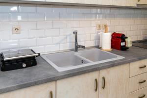 a kitchen counter with a sink and a red appliance at Το Σπίτι της Γιαγιάς 2 (Grandma's House 2) in Kondopoúlion +26 photos