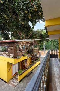 a building with a bench next to a tree at Pousada Dona Elena in Penha