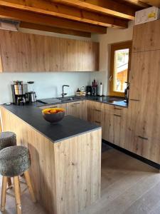 a kitchen with a bowl of oranges on a counter at Chalet avec vue in Nendaz