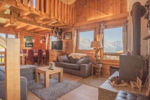 a living room with a couch and a table at Chalet avec vue in Nendaz