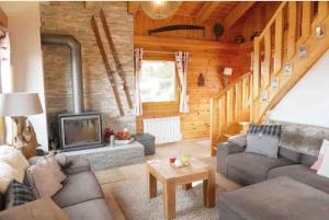 a living room with a couch and a fireplace at Chalet avec vue in Nendaz