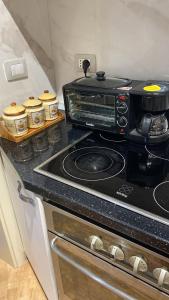 a kitchen with a stove top oven in a kitchen at Dori 's place in Vlorë