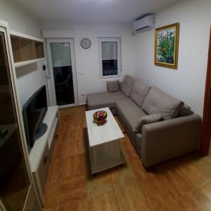 a living room with a couch and a table at Lena in Meljine