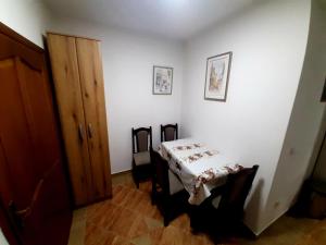 a white room with a table and a wooden door at Lena in Meljine +13 photos