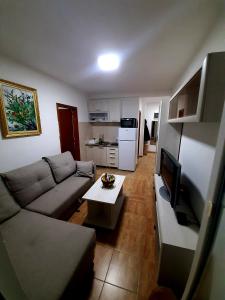 a living room with a couch and a coffee table at Lena in Meljine