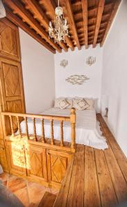 a bedroom with a bed and a chandelier at Unique Stes Lindos in Líndos