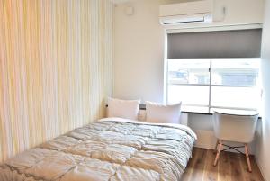 Postel nebo postele na pokoji v ubytování Hostelコトヒラクラスカ