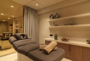a living room with a couch and a chair at Amyth of Mykonos Super Paradise in Super Paradise Beach