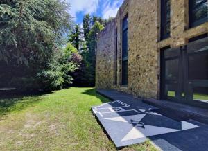 a house with a star on the ground next to a building at AG Casa O Remanso de Pedreira con finca 20000 m2 in Carballo