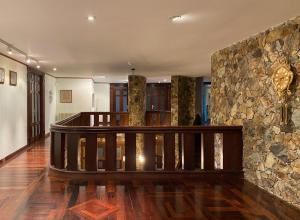 a lobby with a stone wall and a wooden staircase at AG Casa O Remanso de Pedreira con finca 20000 m in Carballo +40 photos