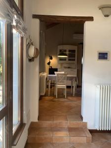 a hallway with a table and a dining room at Il Granaio - Historic Molino Maufet Watermill - Lake Como in Colico