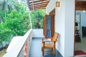 a chair sitting on the porch of a house at Banyan Shade Mirissa in Mirissa