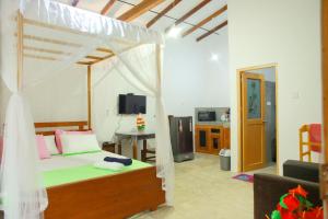 a bedroom with a bed with a canopy at Banyan Shade Mirissa in Mirissa