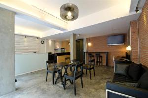 a living room with a table and chairs at DI Place in Bangkok