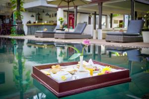 a tray of food sitting in the middle of a swimming pool at Apsara Greenland Boutique Villa & Resort in Siem Reap