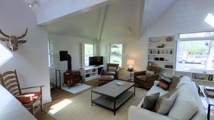 a living room with a couch and a table at Intown Contemporary Prime Street, Fenced Yard, Bright And Open Concept Design in Bozeman