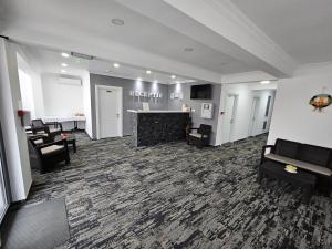 a lobby with chairs and a bar in a building at Ilinca in Neptun