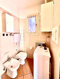 a small bathroom with a toilet and a sink at Canalchiaro55 in Modena +12 photos