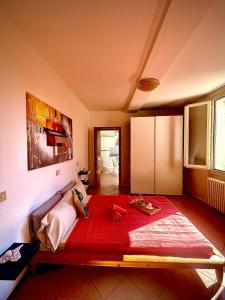 a bedroom with a large bed with a red blanket at Canalchiaro55 in Modena +12 photos