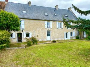 a large brick house with a large yard at La Ferme familiale de Percy - 9 pers in Percy-en-Auge