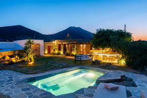 a backyard with a swimming pool and a house at Sifnos Roots in Exámbela