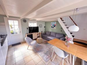 a living room with a couch and a table at Balsemientexel in De Koog