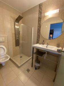 a bathroom with a toilet and a sink and a mirror at KLIO Apartments and Studios in Nei Poroi +67 photos