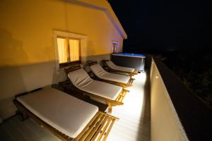 a row of empty beds in a room at night at Residenza Capriccioli in Porto Cervo