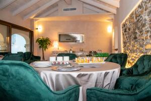 a dining room with a table and green chairs at Vista B&B in Pella
