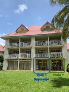 a large building with a sign in front of it at Studio Zandoli P&V in Sainte-Luce +13 photos