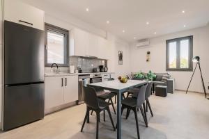 une cuisine et un salon avec une table et des chaises dans l'établissement Koskinou Escape Villa, à Koskinou