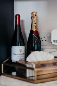 two bottles of wine sitting on top of a counter at Cottage 3 Bed Sleeps 7 Free Parking in Enniskillen